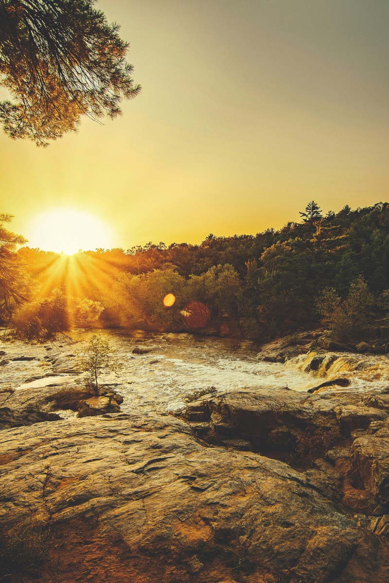 sunrise over a rocky river